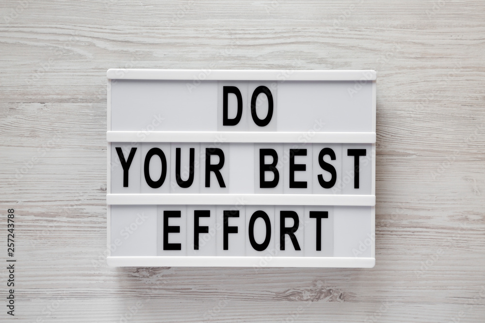 Lightbox with 'Do your best effort' words over white wooden background, top view. Overhead, from above. Flat lay. Close-up.