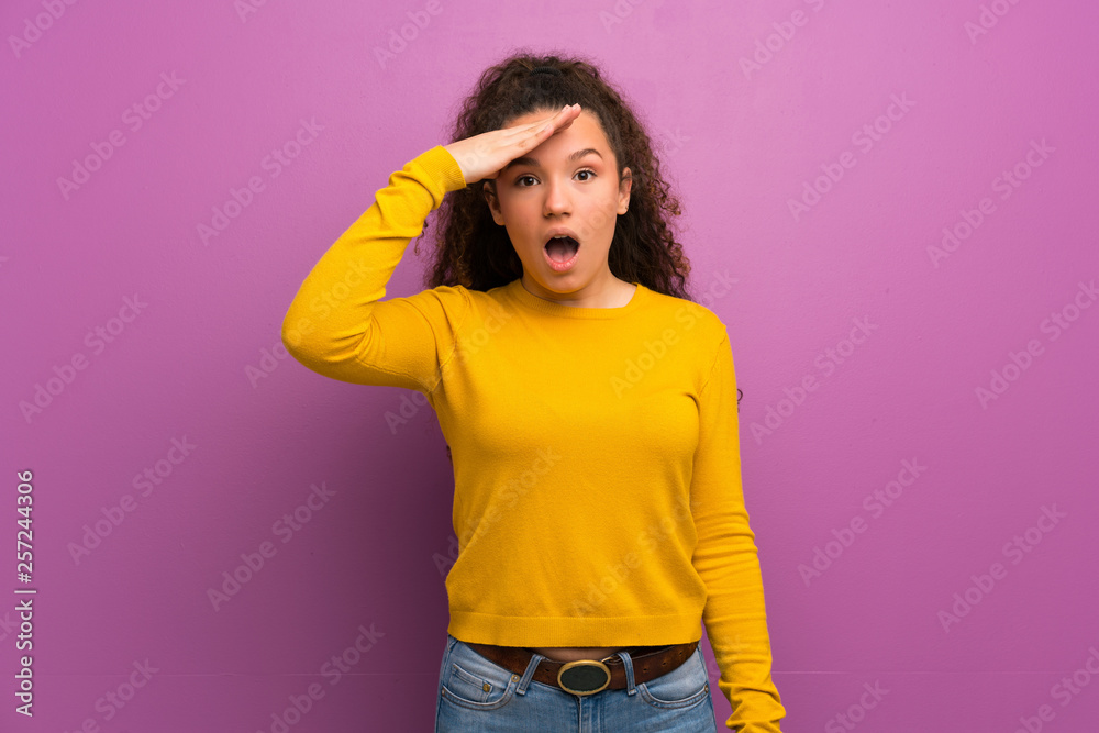 Teenager girl over purple wall has just realized something and has intending the solution Teenager girl over purple wall has just realized something and has intending the solution