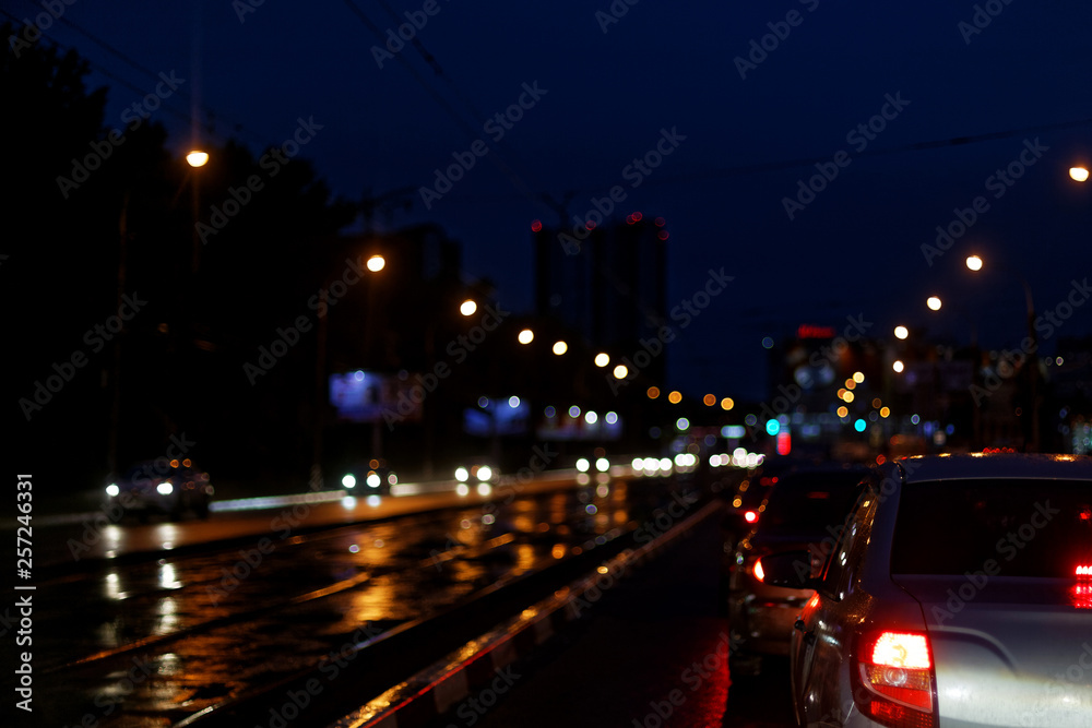 View of night city, cars on the street, blurred light.
