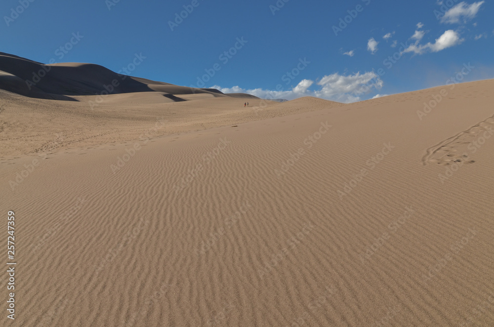 hikers on the slopes of High Dune in Great Sand Dunes National Park and Preserve (Saguache county, Colorado, USA) hikers on the slopes of High Dune in Great Sand Dunes National Park and Preserve (Saguache county, Colorado, USA)