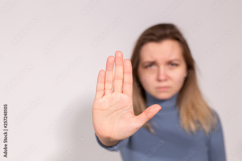 Abuse, domestic violence, protesting and people concept - Stop violence against women on grey background with copy space Abuse, domestic violence, protesting and people concept - Stop violence against women on grey background with copy space