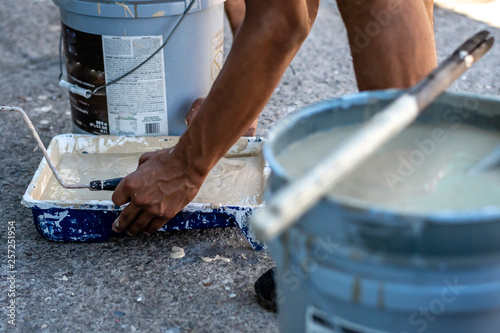 latin man picking up paint in Guatemala