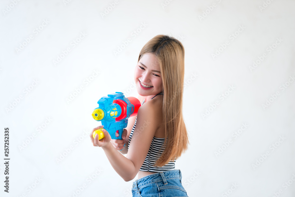Asian sexy woman with gun water in hand on white background,Festival songkran day at thailand,The best of festival of thai,Land of smile Asian sexy woman with gun water in hand on white background,Festival songkran day at thailand,The best of festival of thai,Land of smile