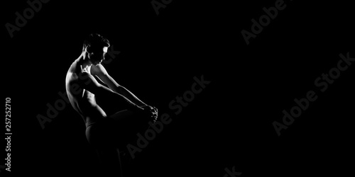 Black and white silhouette of male ballet dancer. Long monochrom horizontal image.