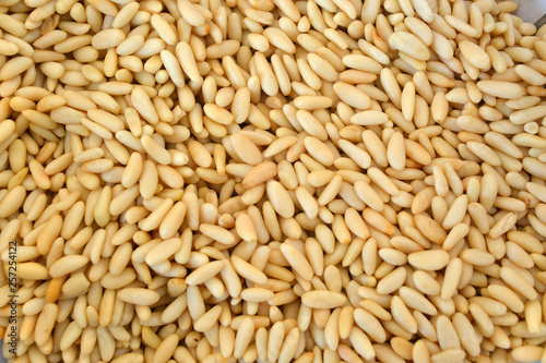 Texture of shelled pine nuts in flat lay angle. photo