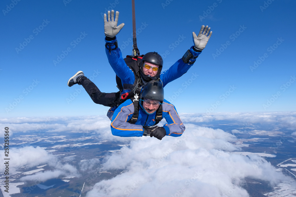 Tandem skydiving. Two guys are having fun in the sky. Tandem skydiving. Two guys are having fun in the sky.