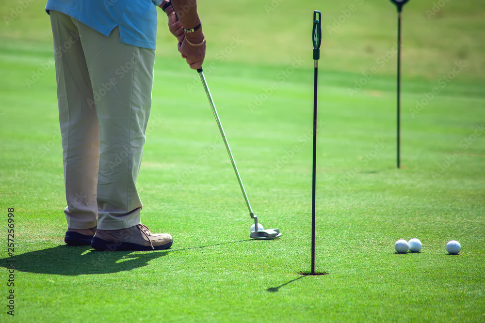 Fototapeta premium Man Playing Golf on Beautiful Sunny Green Golf Course. Sport and lifestyle concept