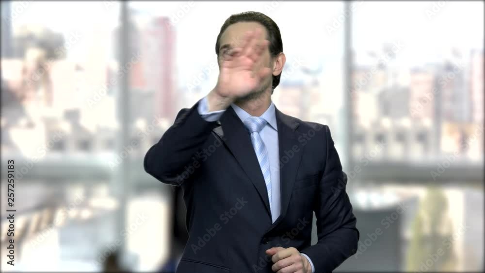 Mature businessman touching virtual screen. Handsome middle-aged manager swiping invisible touch screen interface. People, business and future technology concept. Mature businessman touching virtual screen. Handsome middle-aged manager swiping invisible touch screen interface. People, business and future technology concept.