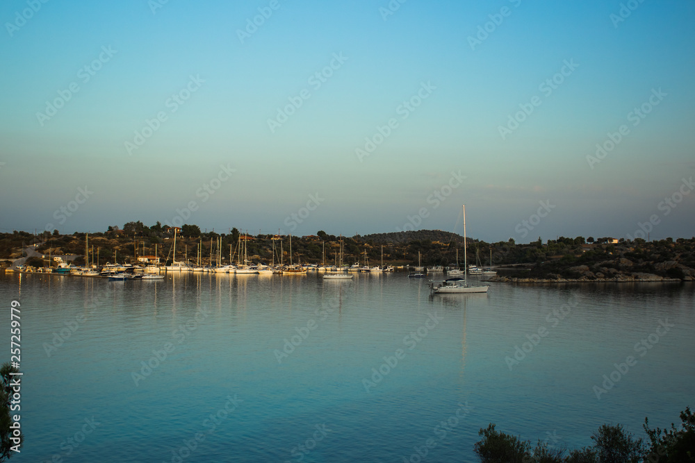 yachts in sea bay near coast line in small harbor place Greece south Aegean waterfront district 