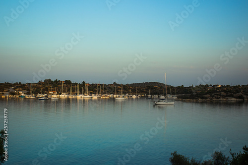 yachts in sea bay near coast line in small harbor place Greece south Aegean waterfront district  © Артём Князь