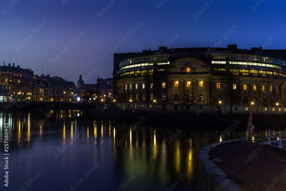 The Swedish Parliament building reflecting in the water at sunset in winter in Stockholm