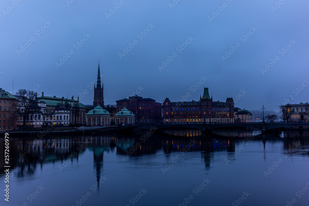 View of the building of the Norstedts Foerlag in Stockholm and the Vasabron bridge reflecting in the sea in the evening