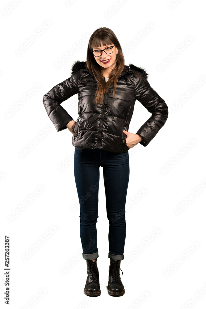 Full-length shot of Woman with glasses posing with arms at hip and smiling Full-length shot of Woman with glasses posing with arms at hip and smiling