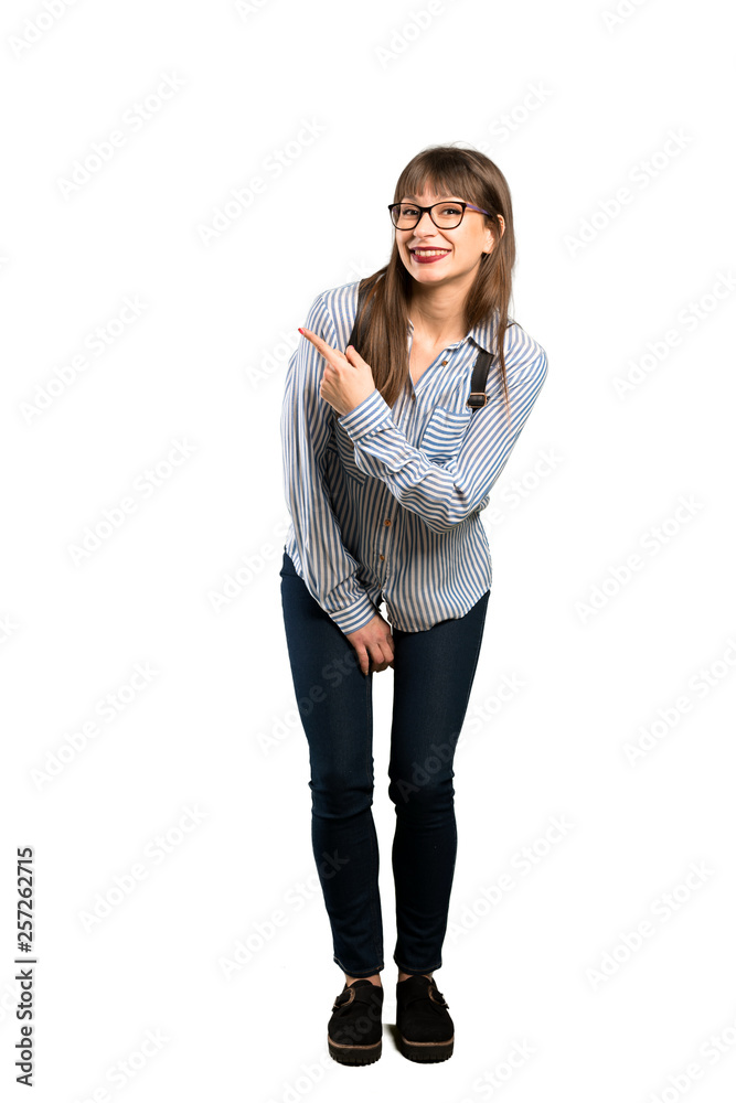 Full-length shot of Woman with glasses pointing to the side to present a product Full-length shot of Woman with glasses pointing to the side to present a product