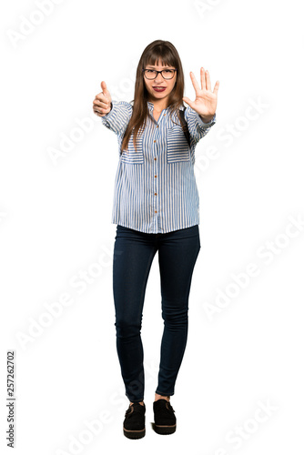 Full-length shot of Woman with glasses counting six with fingers