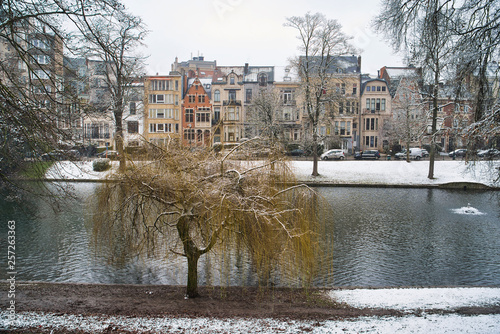 BRUSSELS, BELGIUM - JANUARY 30, 2019: Lake near residential areas, fallen snow, Flagey Avenue photo