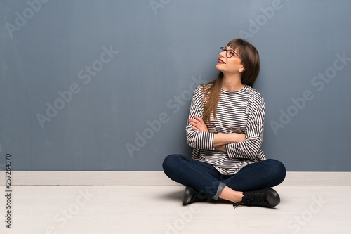Woman with glasses sitting on the floor Happy and smiling © luismolinero