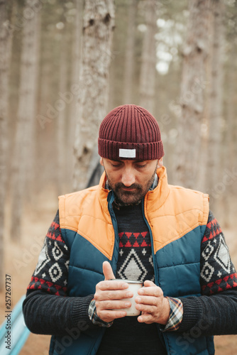 Hiker man drinking, outdoor camping