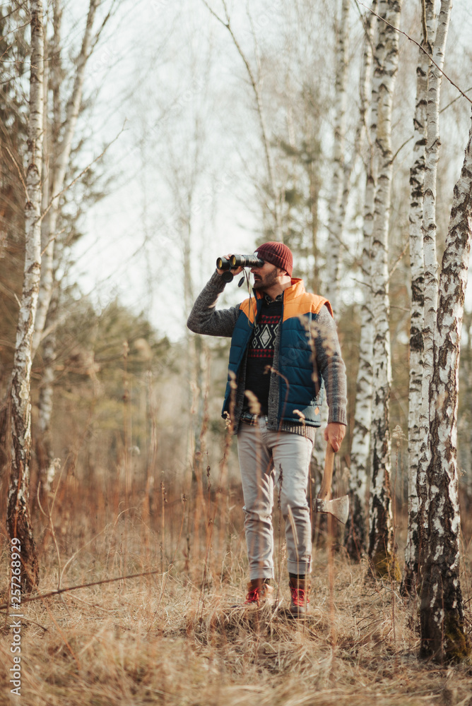 Man with binoculars in the forest