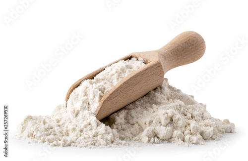 Photo Pile of flour with wooden spoon on a white, isolated.