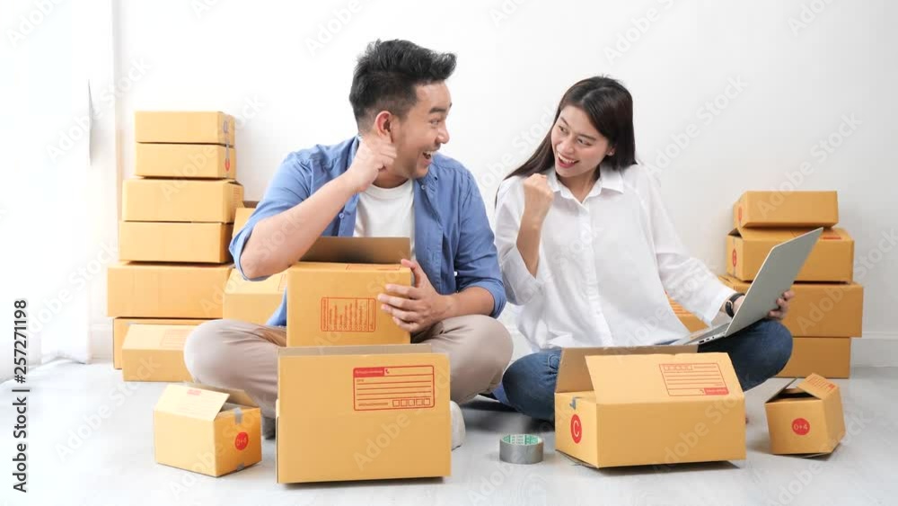 Asian couple with business shopping online happy with success order Asian couple with business shopping online happy with success order