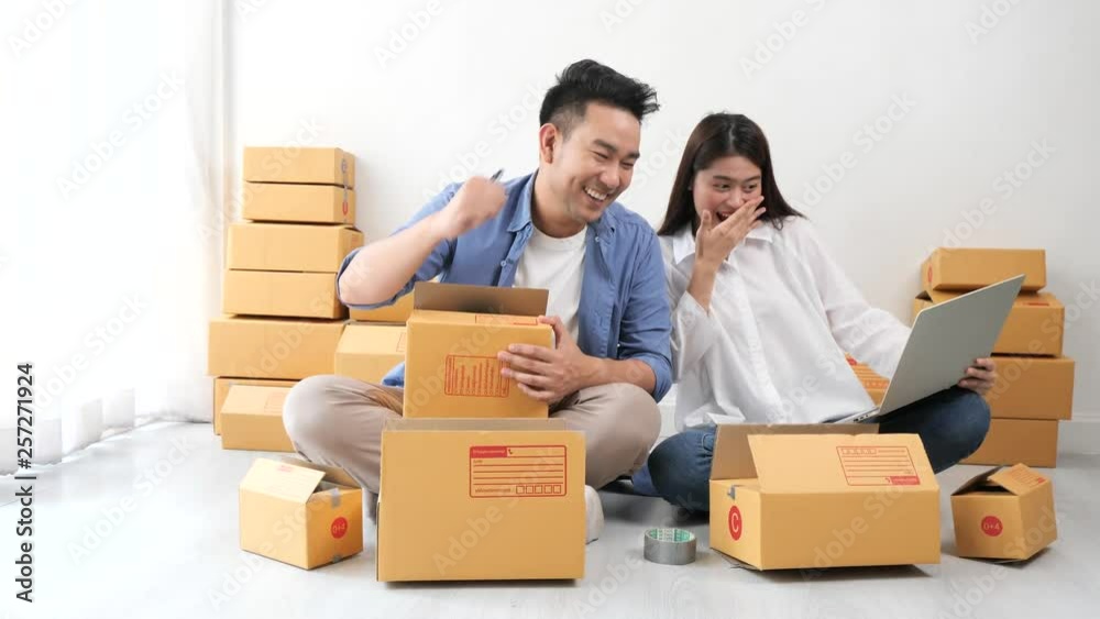 Asian couple with business shopping online happy with success order Asian couple with business shopping online happy with success order