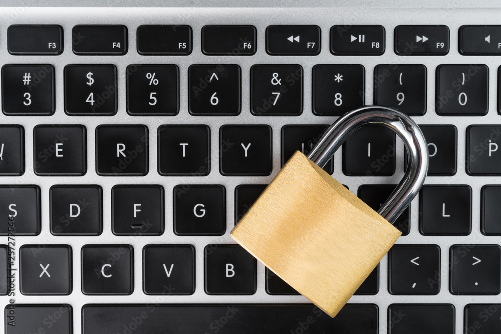 Padlock on a laptop computer keyboard. Cyber security abstract concept. Copy space on the left. Padlock on a laptop computer keyboard. Cyber security abstract concept. Copy space on the left.