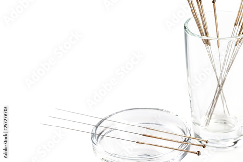 Silver needles for traditional Chinese acupuncture medicine. White background.