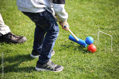 Family playing Croquet