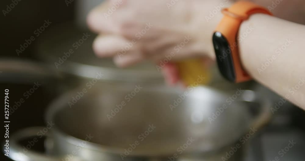 Slow motion of person breaks and puts pasta spaghetti in a pot of boiling water Slow motion of person breaks and puts pasta spaghetti in a pot of boiling water
