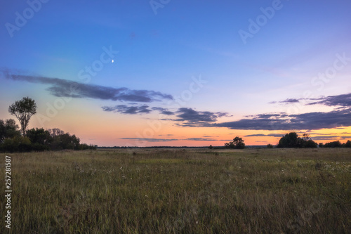 Twilight countryside scenery landscape horizon sunset field blue orange sunset sky with moon 
