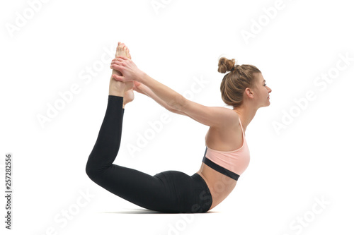 Girl practices yoga isolated on white background.