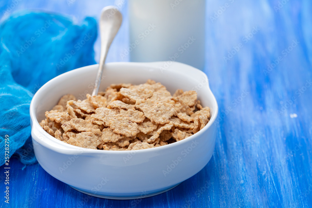 cereals in white bowl on blue background cereals in white bowl on blue background