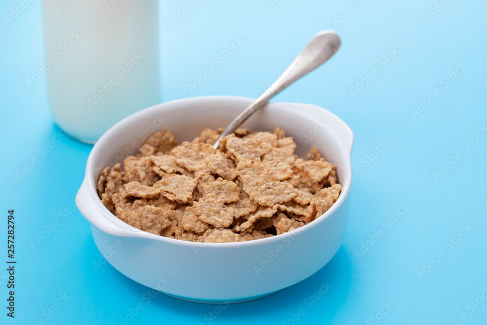 cereals in white bowl on blue background cereals in white bowl on blue background