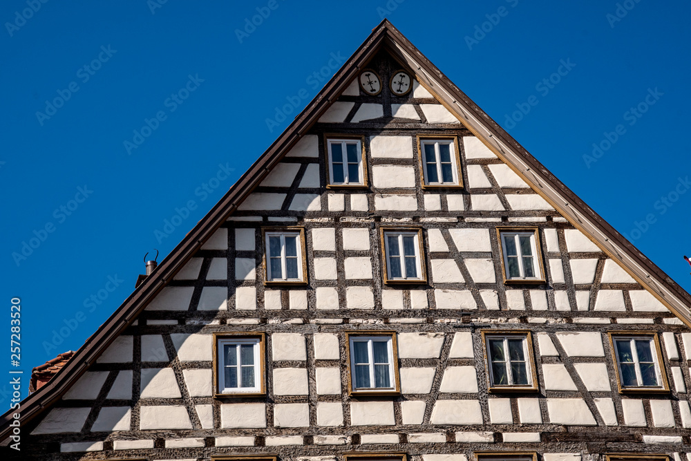 Half-timbered house in Bad Urach on the market square in front of a blue sky