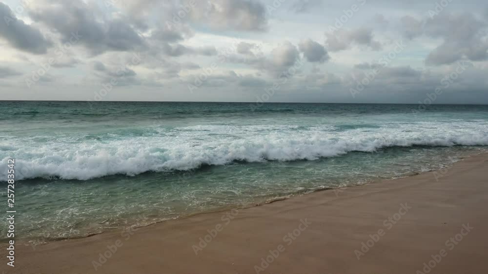 Foaming waves breaking on the sandy beach. Foaming waves breaking on the sandy beach.