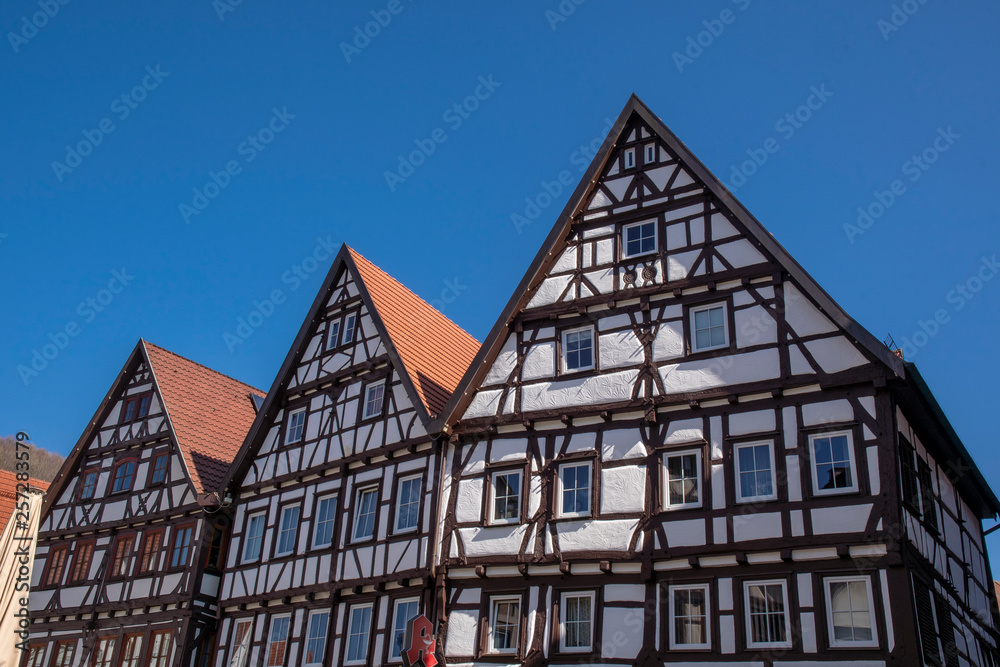 Half-timbered house in Bad Urach on the market square in front of a blue sky