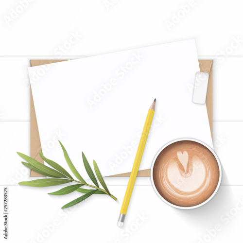 Flat lay top view elegant white composition paper kraft envelope yellow pencil eraser tarragon leaf and coffee on wooden background