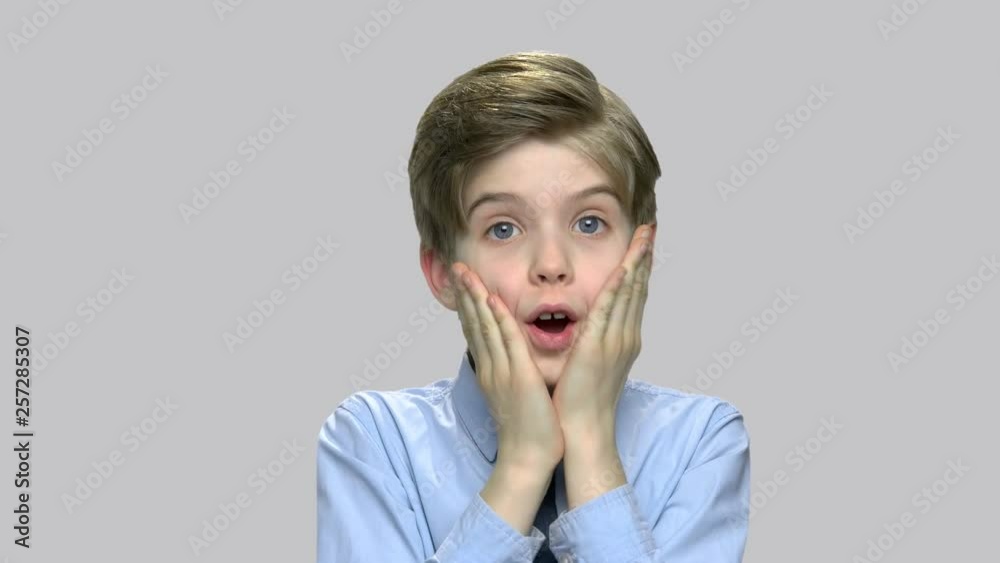 Portrait of frightened child boy. Shocked scared little boy screaming against gray background. Human expression of fear. Portrait of frightened child boy. Shocked scared little boy screaming against gray background. Human expression of fear.