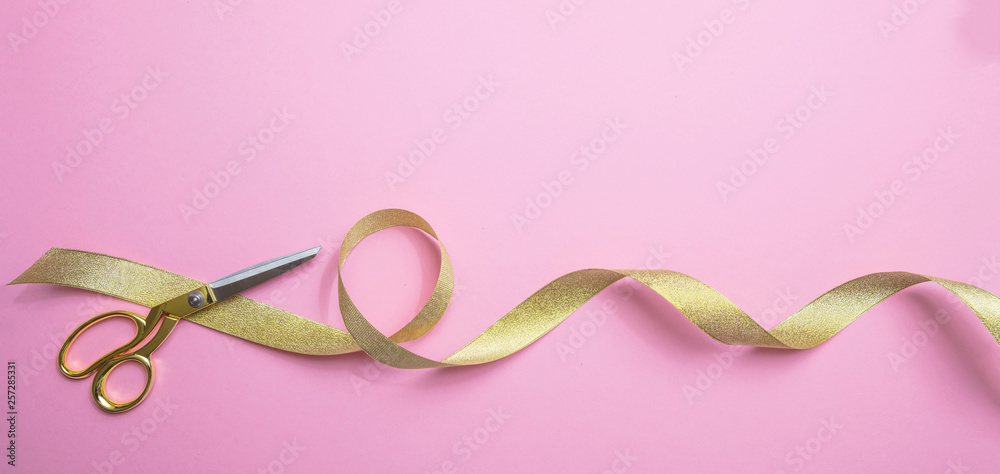 Gold scissors and golden ribbon, pink background, banner