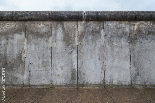 Front view of a section of the original Berlin Wall at the Berlin Wall Memorial (Berliner Mauer) in Berlin, Germany, on a cloudy day. photo