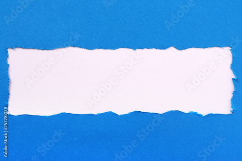 Torn blue paper strip edge border frame center