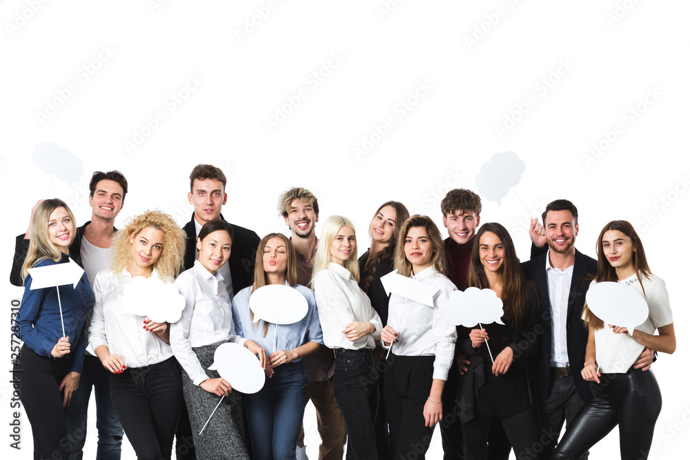 Group of young beautiful women and men in casual wear with clouds of thoughts tags in hands isolated on white background.