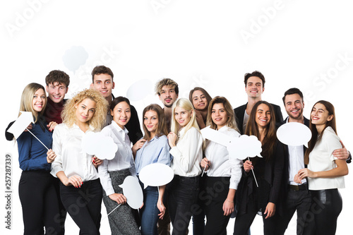 Group of young beautiful women and men in casual wear with clouds of thoughts tags in hands isolated on white background.