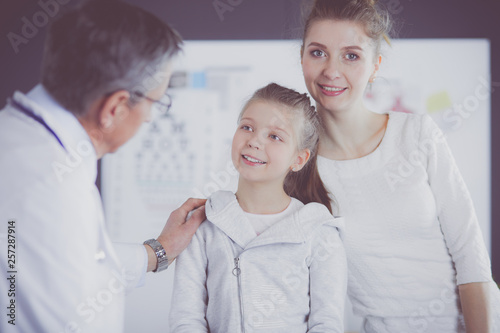 Little girl with her mother at a doctor on consultation