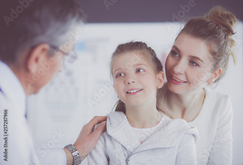 Little girl with her mother at a doctor on consultation