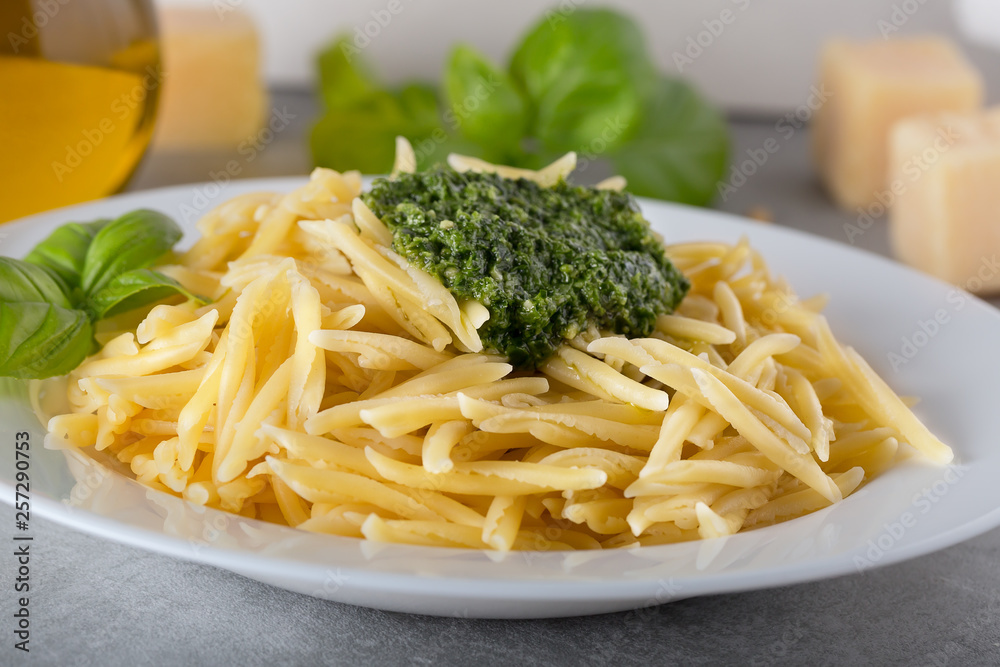 Traditional trofie pasta with pesto sauce on white plate Traditional trofie pasta with pesto sauce on white plate