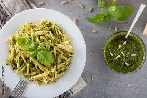 Traditional trofie pasta with pesto sauce on white plate