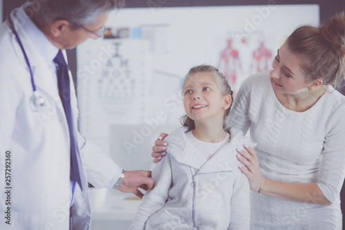 Little girl with her mother at a doctor on consultation