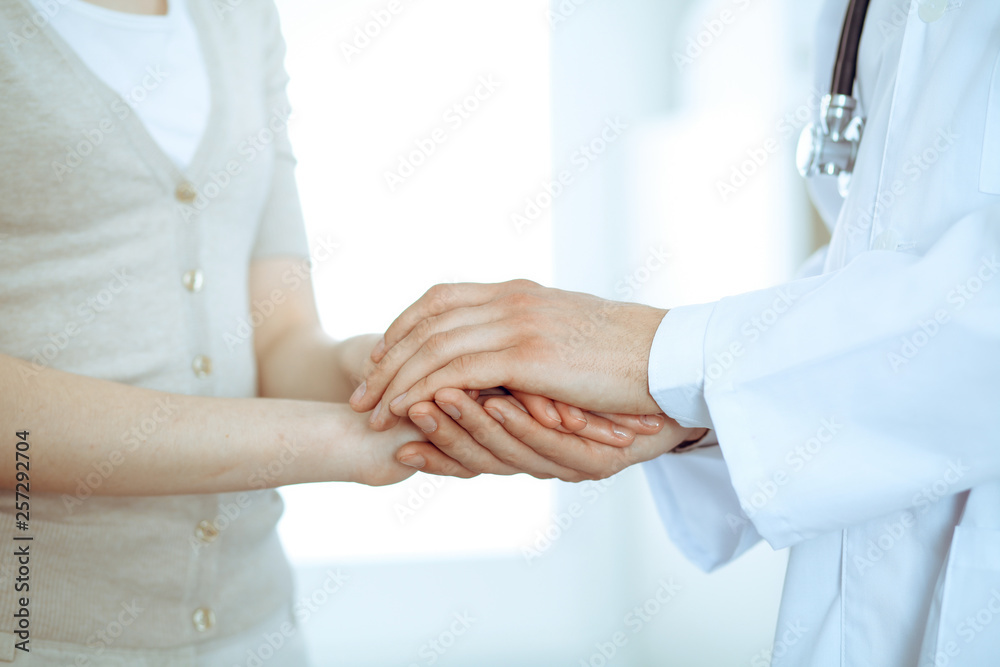 Hand of doctor reassuring her female patient. Medicine and health care concept Hand of doctor reassuring her female patient. Medicine and health care concept